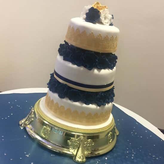 3 tier Wedding Cake on a Bed of Royal Blue Handmade Roses