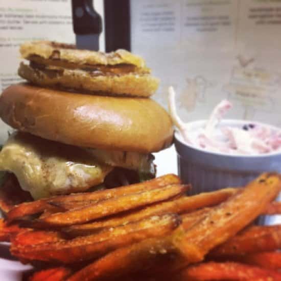 Delicious Grilled Chicken burger topped with Onions Rings - Yum, we know. 