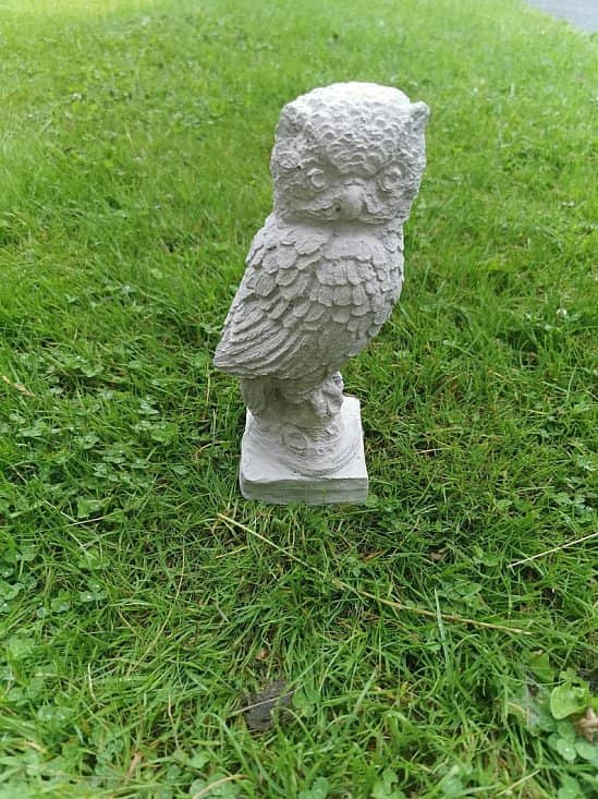 Handmade concrete garden ornament owl on a plynth